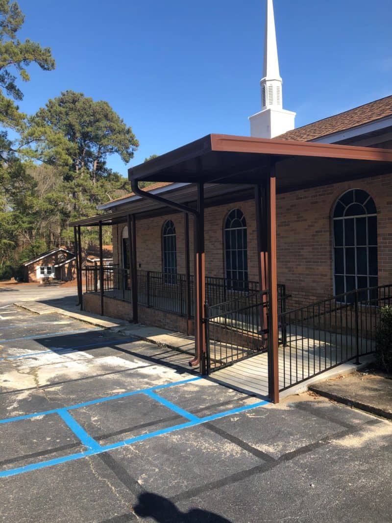 Brown aluminum awning over church entrance