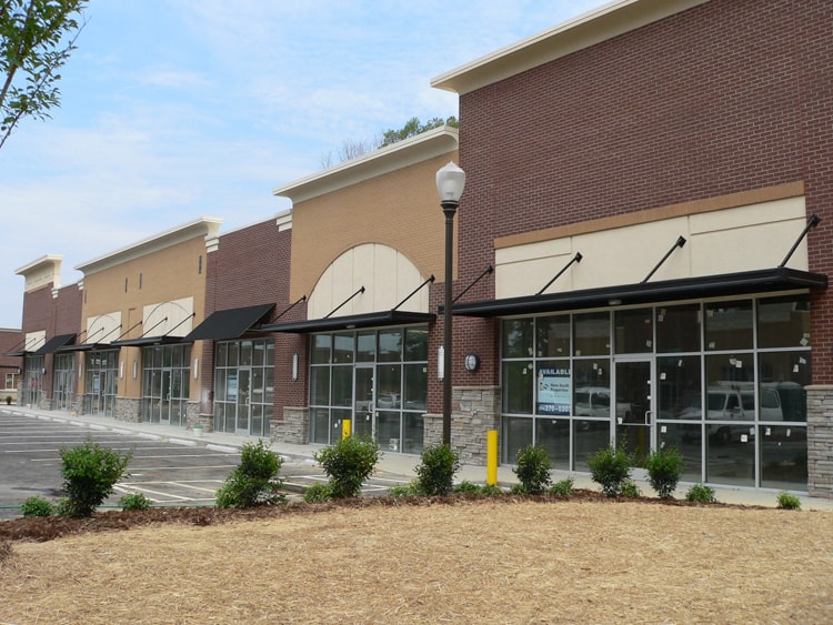Black aluminum awnings over storefront entrances