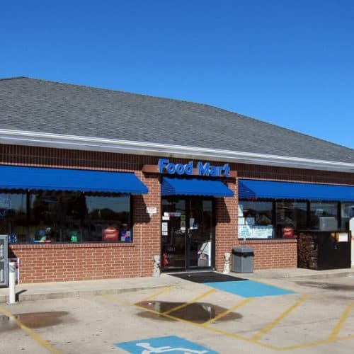 Blue aluminum awnings over gas station store front