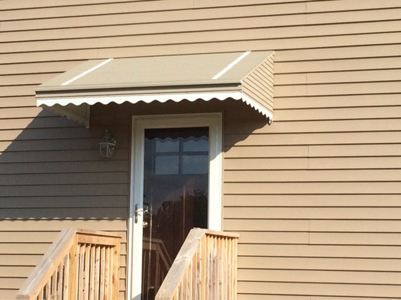 Beige aluminum awning over residential front door