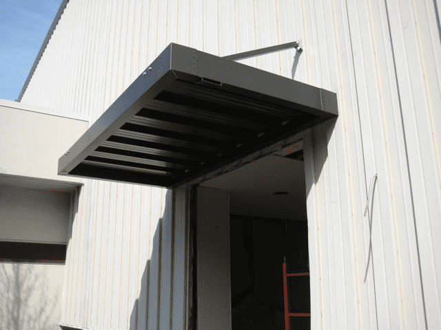 Black aluminum awning over warehouse entrance